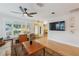Bright living room with hardwood floors, large windows, and seamless flow to other rooms at 106 W Minnehaha St, Tampa, FL 33604