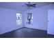 Bedroom with a ceiling fan, a window with curtains, and flooring at 10641 Atlee St, New Port Richey, FL 34654
