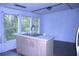 Kitchen island with a sink and windows overlooking the surrounding landscape at 10641 Atlee St, New Port Richey, FL 34654