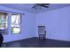 Empty living room with a ceiling fan and a rocking chair at 10641 Atlee St, New Port Richey, FL 34654