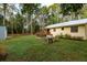 Spacious backyard featuring a wooden deck, grill, hot tub, and fire pit with seating at 10804 Bounty St, New Port Richey, FL 34654