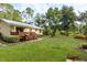 Expansive backyard with a deck, a grill, and a seating area, perfect for outdoor living at 10804 Bounty St, New Port Richey, FL 34654
