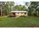 Charming backyard with wooden deck, grill, hot tub, fire pit, and seating area at 10804 Bounty St, New Port Richey, FL 34654