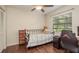 Cozy bedroom with a ceiling fan, a large window, and hardwood floors at 10804 Bounty St, New Port Richey, FL 34654