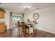 Open-concept dining area with wood flooring, pendant lighting, and sliding door to patio at 10804 Bounty St, New Port Richey, FL 34654