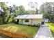 Quaint home with metal roof, tidy lawn and landscaping and concrete driveway to outbuilding at 10804 Bounty St, New Port Richey, FL 34654