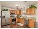 Well-lit kitchen featuring stainless steel appliances, granite countertops, and wooden cabinets at 10804 Bounty St, New Port Richey, FL 34654
