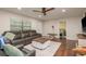 Comfortable living room with hardwood floors, ceiling fan and view to the bedroom at 10804 Bounty St, New Port Richey, FL 34654