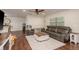 Spacious open-concept living room with hardwood floors, ceiling fan, view to dining room and large window at 10804 Bounty St, New Port Richey, FL 34654