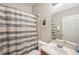 Cozy bathroom featuring a shower-tub combo with a patterned curtain and a sink with a mirror at 10905 Wildcat Dr, Riverview, FL 33579