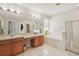 Bright bathroom featuring dual sinks, vanity, soaking tub and shower at 10905 Wildcat Dr, Riverview, FL 33579
