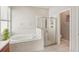 Bathroom featuring soaking tub, separate glass shower, and modern fixtures at 10905 Wildcat Dr, Riverview, FL 33579