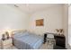 Cozy bedroom with a wood bed frame, a sailboat painting, and a writing desk at 10905 Wildcat Dr, Riverview, FL 33579