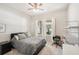 Comfortable bedroom with three windows, a ceiling fan, and neutral decor at 10905 Wildcat Dr, Riverview, FL 33579
