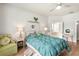 Spacious bedroom boasts wood floors, soft chair and ensuite bath at 10905 Wildcat Dr, Riverview, FL 33579