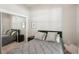 Bedroom featuring a mirrored closet door, neutral decor and natural light at 10905 Wildcat Dr, Riverview, FL 33579