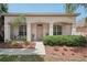Inviting front porch with decorative landscaping and a seating area offers curb appeal and charm at 10905 Wildcat Dr, Riverview, FL 33579