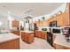 Functional kitchen featuring wooden cabinets, tile flooring, modern appliances, and ample counter space at 10905 Wildcat Dr, Riverview, FL 33579