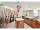 Open kitchen with an island, stainless steel appliances, and lots of cabinets create a functional and inviting space at 10905 Wildcat Dr, Riverview, FL 33579