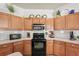Well-lit kitchen with updated appliances, lots of cabinets, and a breakfast bar, perfect for modern convenience at 10905 Wildcat Dr, Riverview, FL 33579