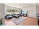 Spacious living room with a large window overlooking the backyard and comfortable seating, ideal for relaxation at 10905 Wildcat Dr, Riverview, FL 33579