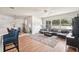 Open-concept living room features wood flooring, large windows, and seamless flow to the dining area at 10905 Wildcat Dr, Riverview, FL 33579