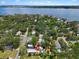 Aerial view of the property with the pool, mature trees, and proximity to the waterway at 111 29Th W St, Bradenton, FL 34205