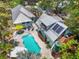 Aerial view of the house with pool, solar panels, and a charming outdoor patio at 111 29Th W St, Bradenton, FL 34205