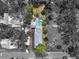 Aerial view of the home with a pool, yard, and surrounding trees in a neighborhood setting at 111 29Th W St, Bradenton, FL 34205