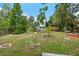 Spacious backyard with mature trees, a deck, and room to roam at 111 29Th W St, Bradenton, FL 34205