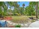 Large backyard space with lush greenery, palm trees, and a stone pathway at 111 29Th W St, Bradenton, FL 34205
