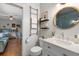 Stylishly decorated bathroom leading to bedroom with hardwood floors, ladder towel rack, and decorative shelves at 111 29Th W St, Bradenton, FL 34205