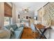 Bedroom with hardwood floors, woven shades, cozy couch, desk area, and a comfortable bed; ideal for relaxation at 111 29Th W St, Bradenton, FL 34205