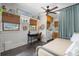 Inviting bedroom with a dedicated desk space, laundry facilities, warm window treatments, and a comfortable daybed at 111 29Th W St, Bradenton, FL 34205
