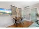 Bedroom with a desk, couch, and TV, complemented by hardwood floors and a stylish design, ideal for relaxation at 111 29Th W St, Bradenton, FL 34205