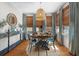 Bright dining room featuring a round wooden table, blue chairs, and natural light from surrounding windows at 111 29Th W St, Bradenton, FL 34205
