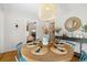 Bright dining room featuring a round wooden table, blue chairs, and natural light from surrounding windows at 111 29Th W St, Bradenton, FL 34205