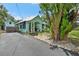 Charming home with blue trim, front porch, and mature landscaping at 111 29Th W St, Bradenton, FL 34205