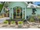 Charming home featuring a cheerful yellow door, complemented by rocking chairs on the welcoming front porch at 111 29Th W St, Bradenton, FL 34205