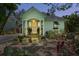 Charming home featuring a cheerful yellow door, complemented by rocking chairs on the welcoming front porch at 111 29Th W St, Bradenton, FL 34205