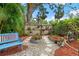 Beautiful garden featuring a variety of plants, a birdbath, and a blue bench for relaxing at 111 29Th W St, Bradenton, FL 34205