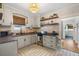 Well-lit kitchen featuring stainless steel appliances, granite countertops, and white cabinets at 111 29Th W St, Bradenton, FL 34205