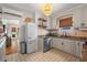 Well-lit kitchen featuring stainless steel appliances, granite countertops, and white cabinets at 111 29Th W St, Bradenton, FL 34205