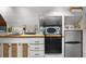 A charming kitchenette featuring white cabinets and modern appliances for convenient meal preparation at 111 29Th W St, Bradenton, FL 34205