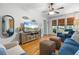 Inviting living room with hardwood floors, a plush blue sofa, and natural light streaming through window blinds at 111 29Th W St, Bradenton, FL 34205