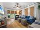 Inviting living room with hardwood floors, a plush blue sofa, and natural light streaming through window blinds at 111 29Th W St, Bradenton, FL 34205