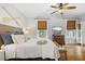 Cozy main bedroom with hardwood floors, soft bedding, and natural light streaming through the window at 111 29Th W St, Bradenton, FL 34205