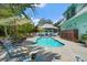 Tranquil backyard featuring a sparkling pool, lounge chairs, and lush greenery, creating a serene retreat at 111 29Th W St, Bradenton, FL 34205