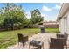 Backyard features a grassy lawn, patio, grill and outdoor seating, with a wood fence at 11320 125Th Ter, Largo, FL 33778