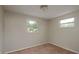 This cozy bedroom has neutral walls, carpet, and two windows offering natural light at 11320 125Th Ter, Largo, FL 33778